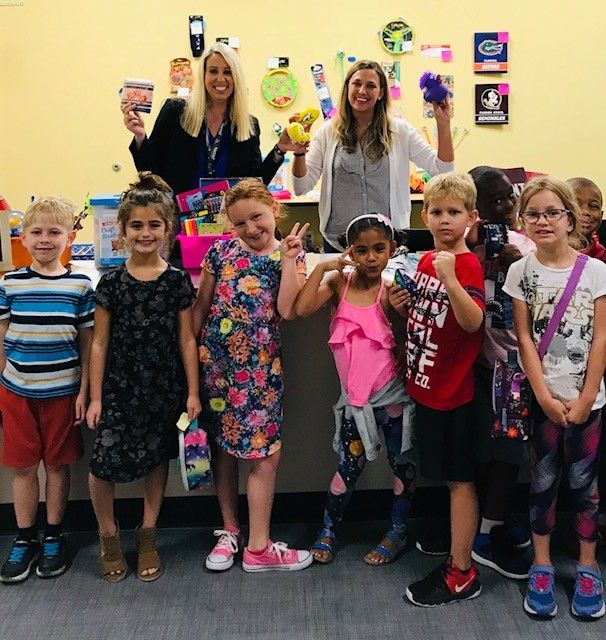 Teachers and students celebrating at a LiveSchool reward store